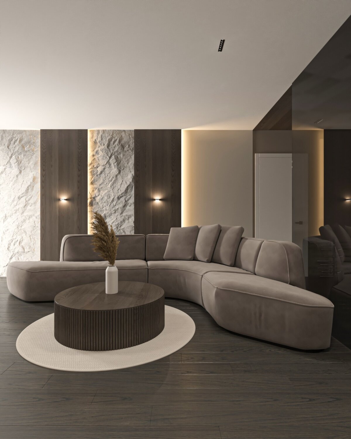 Hobbyraum in Zürich: geschwungenes Sofa mit rundem Couchtisch vor beleuchteter Natursteinwand